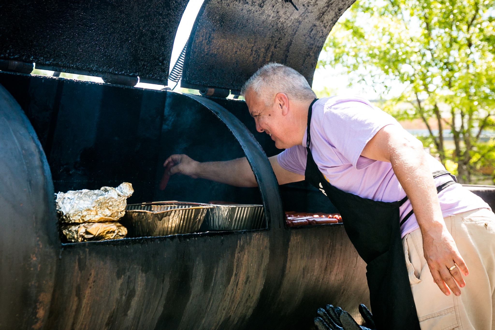 Pitmaster checking the smoker at the BBQ cook-off